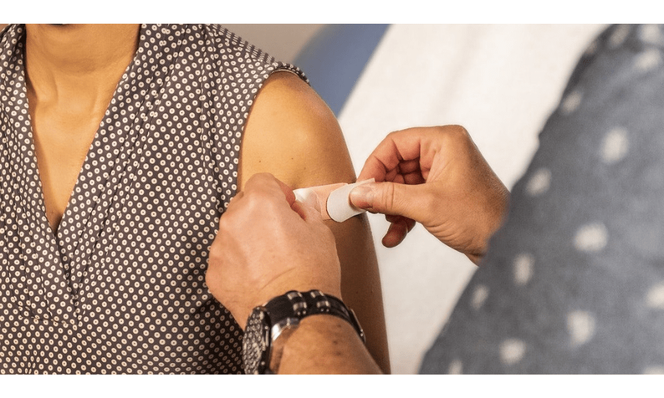 Person Getting a Bandage After A Vaccine